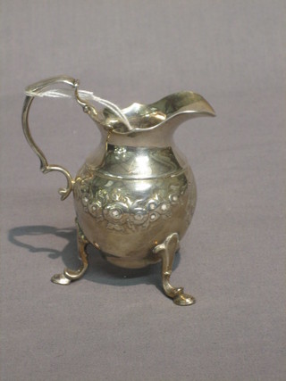 A George III embossed silver cream jug raised on 3 hoof feet, London 1781, 5 ozs