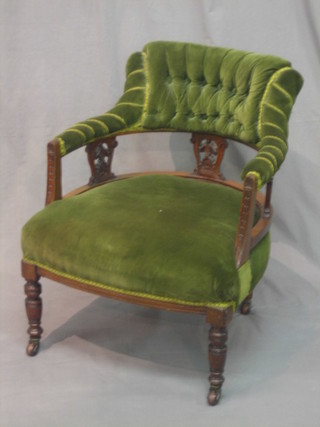 A Victorian carved walnut tub back chair upholstered in green material