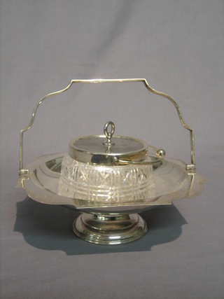 A cut glass twin handled preserve jar with silver plated cover and a swing handled cake basket