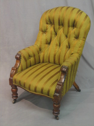 A Victorian mahogany tub back chair upholstered in striped material, raised on turned supports