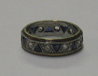 A gold full eternity ring set blue and white stones
