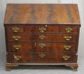 A George III mahogany bureau, the fall front revealing a well fitted interior above 1 long, 2 short and 3 long drawers, raised on bracket feet