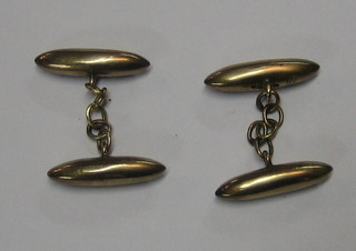 A pair of gold torpedo shaped cufflinks