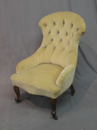 A Victorian mahogany tub back chair upholstered in cream buttoned material, raised on cabriole supports