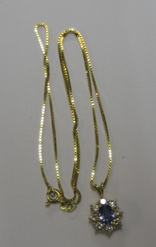 A gold pendant set a pale Ceylon sapphire surrounded by diamonds