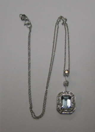 A lady's attractive lozenge shaped pendant set an aquamarine surrounded by diamonds and with 2 diamonds above, hung on a fine gold chain (approx 0.60/1.60ct)
