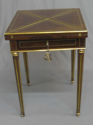 A 19th/20th Century handsome Continental mahogany and brass bound envelope card table raised on turned and fluted supports 21 1/2"