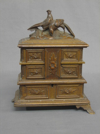 A French carved walnut jewellery box, the lid decorated pheasants 