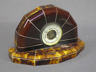 A 1930's aneroid barometer with porcelain dial contained in a tortoiseshell brown tiled case