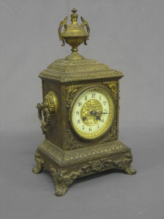 A 19th Century French 8 day striking mantel clock contained in an ornate gilt case surmounted by an urn