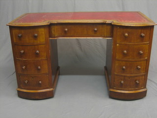 A Victorian walnut kneehole pedestal desk with inset tooled leather writing surface, above 1 long and 8 short drawers, raised on a platform base, 48"