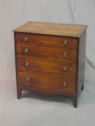 A 19th Century mahogany commode in the form of a chest with hinged front, fitted dummy drawers, raised on bracket feet 25 1/2"