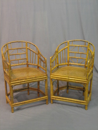 A pair of bamboo armchairs with woven rush seats