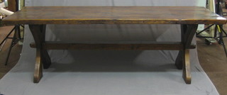 A 17th Century style oak refectory dining table raised on X framed supports with H framed stretcher 89"