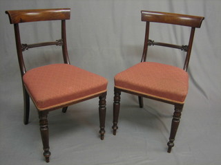 A pair of 19th Century mahogany bar back dining chairs with shaped mid rail, raised on turned supports