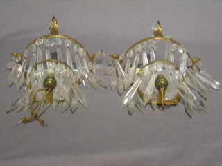A pair of gilt metal and cut glass lozenge wall brackets