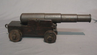 An iron cannon with 12" barrel raised on a wooden trunion