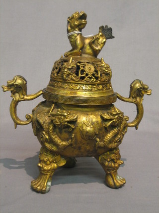 A 19th/20th Century bronze twin handled Koro, raised on 3 hoof feet with pierced dragon decoration 12"