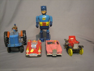 A Japanese battery operated tin plate robot model of Batman, a British tin plate model of a racing car, a Minic plastic clock work model of a vintage car, a plastic model of a tractor and a plastic model of Lady Penelope's pink Rolls Royce