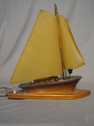 A 1930's wooden table lamp in the form of a yacht 17"