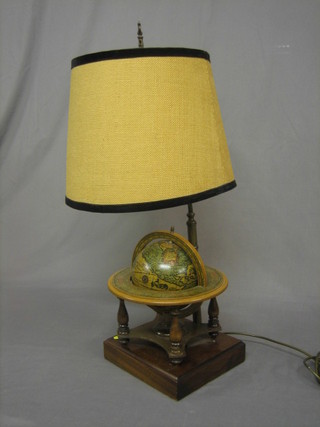 A 1950's/60's table lamp the base decorated a musical globe