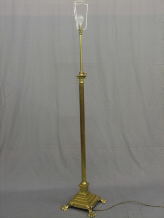 A reeded brass adjustable standard lamp with Corinthian column on a stepped base