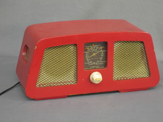 A Supervox radio by McMichael in a red painted case