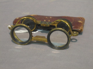 A pair of Victorian brass opera glasses by Aitchinson Company patented 24 88 3, contained in a leather case