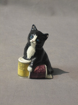 A Royal Doulton figure of a seated cat with 2 tins of cat food 2 1/2"