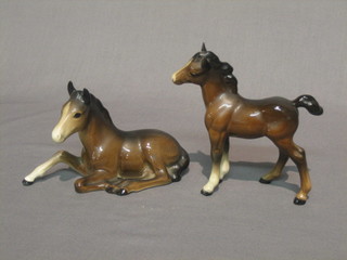 A Beswick figure of a seated foal, base marked 915 4" and a do. standing horse 4"