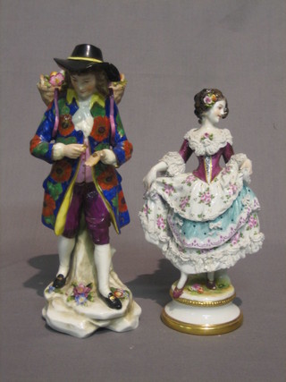 A Continental figure of a standing gentleman with basket work panier 9" (f) and a do. figure of a Crinoline lady 9" (f)