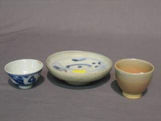An Oriental provincial saucer dish with blue and white decoration 5" and a Oriental blue and white tea bowl 2" and 1 other