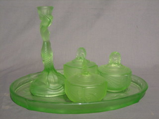 A green glass 5 piece dressing table set with oval tray, candlestick and 2 jars and covers