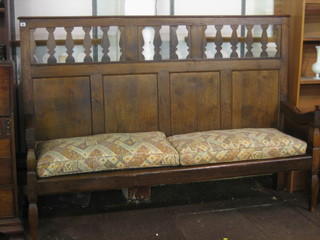 A 19th Century oak settle with pierced and panelled back 77"