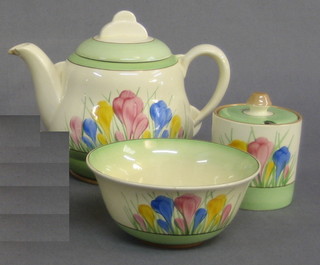 A 4 piece Clarice Cliff Pastel Crocus pattern tea service comprising tea pot (cracked), sugar bowl (crazed), milk jug and a preserve jar and cover (chipped)