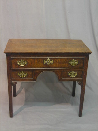An 18th Century oak low boy, fitted 1 long drawer and 2 short drawers, raised on square supports 32"