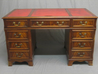 A Georgian style kneehole pedestal desk with inset tooled leather writing surface above 9 drawers, raised on bracket feet 54"