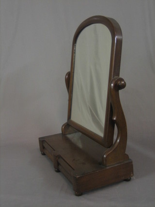 A Victorian arch plate dressing table mirror contained in a mahogany swing frame, the base fitted 2 drawers 21"