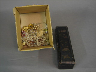 A rectangular lacquered glove box with hinged lid and a small collection of costume jewellery