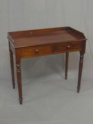A Victorian mahogany writing table/wash stand with three-quarter gallery, fitted 2 long drawers and raised on turned supports 36"