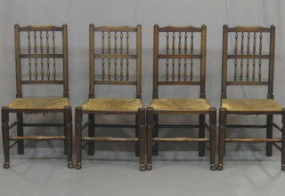 A set of 4 elm spindle back dining chairs with woven cane seats, raised on club supports