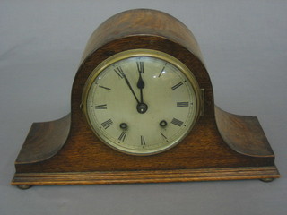 A 19th Century striking mantel clock with silvered dial and Roman numerals contained in an arch shaped case