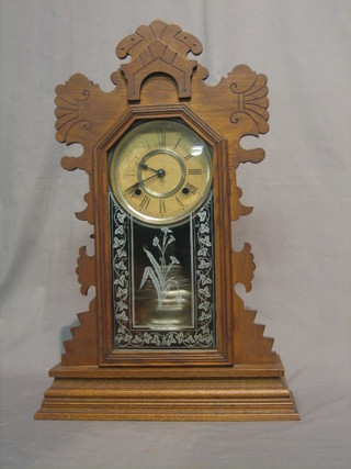 An American 8 day striking shelf clock with paper dial and Roman numerals contained in a carved pine and oak case