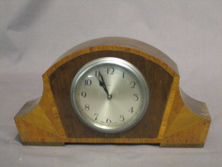 An 8 day bedroom timepiece with silvered dial and Arabic numerals contained in an inlaid oak case