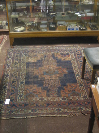 An Eastern Caucasian blue ground rug with central medallion within multi-row borders 74" x 58"