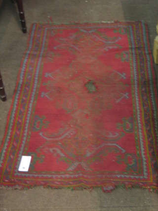 A 19th Century Turkey rug (hole to centre and worn) 65" x 38"