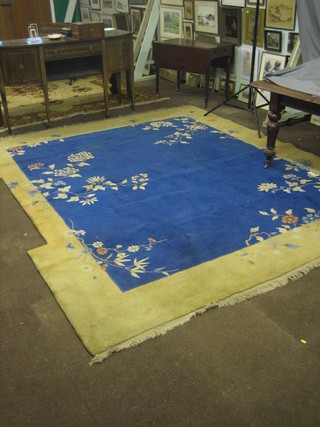 A 1930's blue and yellow ground Chinese carpet with floral decoration 126" x 109 (cut for fire place)