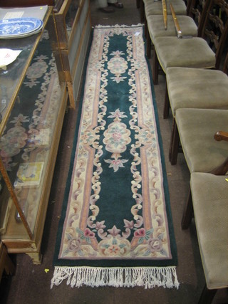 A Chinese green ground and floral pattern  runner 131" x 27" 