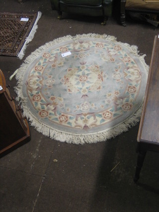 A Chinese circular green ground and floral pattern rug  50"