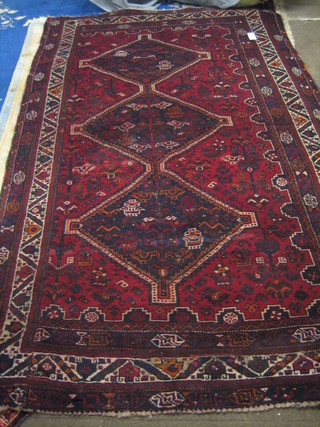A contemporary red ground Shiraz rug with 3 diamonds to the centre within multi-row borders 123" x 74"
